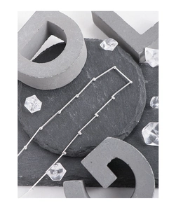 Detailed close-up of S925 sterling silver bamboo joint necklace on stone texture