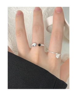 Close-up of S925 sterling silver geometric U-shaped ring with black onyx on woman's finger