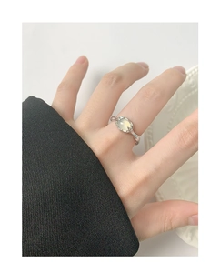Detail of S925 sterling silver ring featuring an oval opal gemstone and textured band