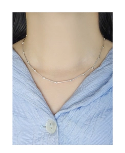 Detailed view of an S925 sterling silver minimalist bamboo link necklace on neck