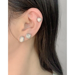 Three-piece S925 silver earring set with heart, square and oval opal stones worn on ear