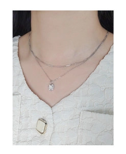 Close-up of double-layered S925 silver necklace with heart agate pendant on model
