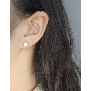 S925 sterling silver heart earrings with textured frame and iridescent pearl on model
