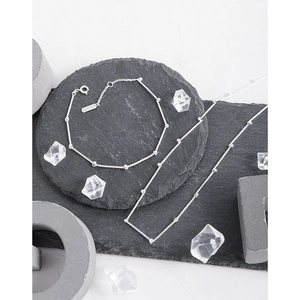 Minimalist S925 sterling silver bamboo link necklace and bracelet set on stone blocks