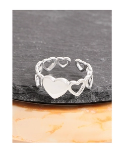 Detail of silver heart ring with solid center and hollow side patterns on stone