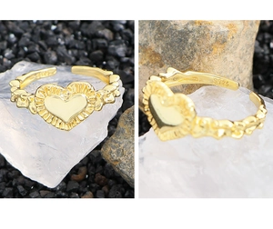 Detail of S925 sterling silver gold heart ring with pleated texture and inner hallmark