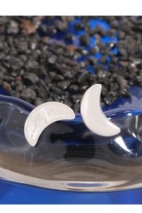 Macro shot of S925 sterling silver crescent moon earrings with white glazed finish