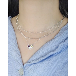Layered S925 silver necklace with heart pendant and multicolor gemstones on neck