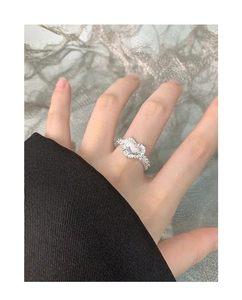 Close-up of S925 sterling silver heart ring with pleated texture on model's finger