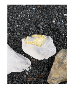 Close-up of S925 sterling silver heart ring with molten texture on white crystal