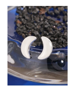 Macro view of silver crescent moon stud earrings with white enamel on black stones