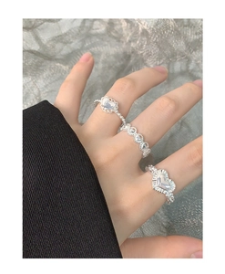 Detailed view of silver heart rings with pleated textures and hollow heart designs