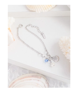 Detailed macro shot of S925 sterling silver lobster clasp with shell and pearl charms
