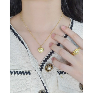 Elegant gold heart pendant necklace and ring set with textured edges for women