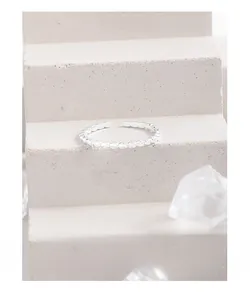 Detail shot of a minimalist S925 sterling silver square band ring with textured finish