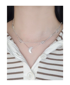Close-up of double-layered S925 silver necklace with moon pendant and oval link chain