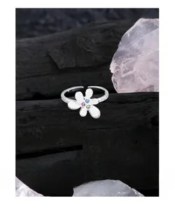 Macro shot of S925 sterling silver floral ring with blue pink and champagne zircon stones