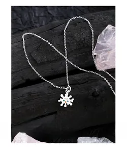 Macro shot of 925 sterling silver star pendant with multi-colored zirconia stones