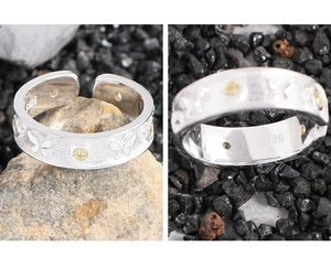 Detailed macro view of S925 silver butterfly ring with matte texture and yellow zircon