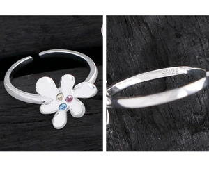 Macro shot of S925 sterling silver stamp and colorful zircon petals on the floral ring
