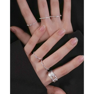 Minimalist S925 sterling silver ring set with zircon accents on a female model hand