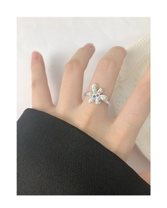 Macro detail of silver S925 flower ring with colorful zircon petal inlay on hand