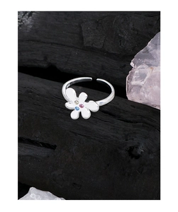 Detail of S925 silver flower ring featuring colorful zircon center and white enamel petals