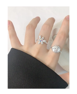 Detail view of S925 silver flower ring with colorful zircons and spiral bud design