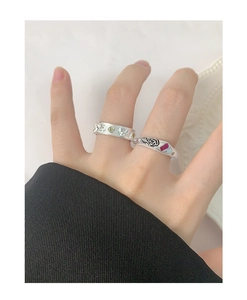 Detail of S925 silver rings featuring butterfly zircon and rose ruby relief design