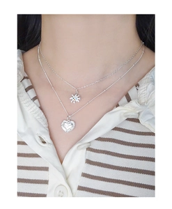 Close-up of double-layer silver S925 necklace with colorful zircon star and heart pendant