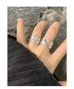 Close-up of minimalist S925 silver hollow heart rings on model's hand with y2k aesthetic