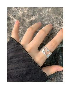 Detail shot of wide S925 silver ring featuring a hollow heart cutout on a woman's hand