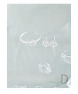 Macro view of S925 sterling silver star ring and earrings set with hallmark detail