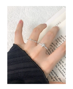 Detail shot of a silver star ring set on a hand with an aesthetic book background