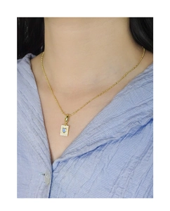 Close-up of S925 silver bear heart necklace with blue zircon pendant on model neck