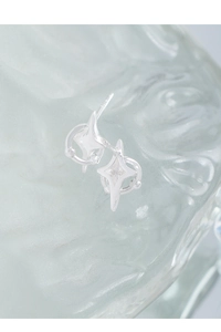Macro shot of silver star stud earrings with S925 hallmark on glass background
