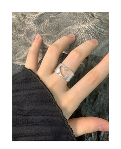 Detail of S925 sterling silver ring featuring irregular lava texture and hollow heart design