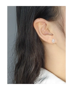 Close-up of S925 sterling silver four-pointed star stud earring on model's ear lobe