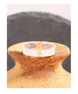 Detail of S925 sterling silver open ring featuring a gold star on a wide silver band