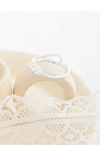 Macro detail of S925 sterling silver stamp on minimalist spiral geometric ring