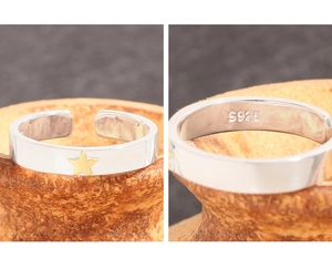 Close-up of S925 sterling silver ring featuring a gold star and adjustable band design