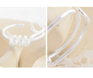 Macro shot of S925 sterling silver stamp on minimalist spiral geometric ring band