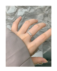 Close-up of minimalist S925 sterling silver ring with spiral twisted design on finger