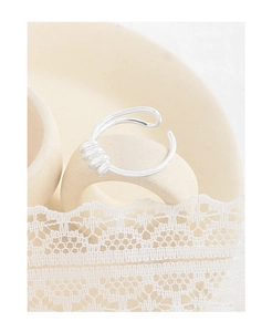 Detailed macro view of S925 sterling silver stamp on minimalist spiral geometric ring