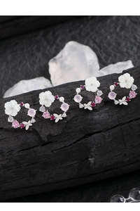 Macro shot of S925 silver shell flower earrings with pink and red zircon gems