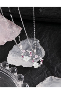 Macro view of S925 silver necklace with shell flower and colorful zirconia detail
