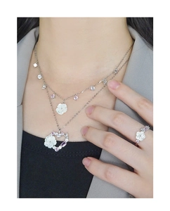 Detailed close-up of S925 silver shell flower ring and layered necklace set on model