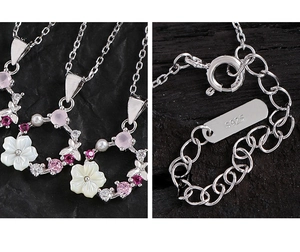Detail of S925 silver necklace featuring shell flower and pink zircon on black stone