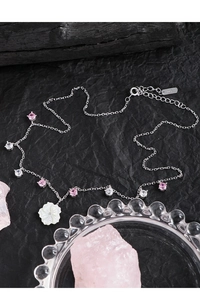 Close-up of S925 silver necklace with shell flower pendant and pink cubic zirconia