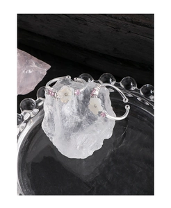 Macro shot of S925 silver ring featuring a shell flower and pink crystal accents